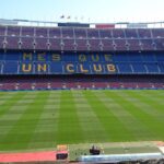 Panoramic view of Camp Nou stadium in Barcelona, home of FC Barcelona football team, with 'Mes Que Un Club' slogan.