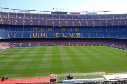 Panoramic view of Camp Nou stadium in Barcelona, home of FC Barcelona football team, with 'Mes Que Un Club' slogan.