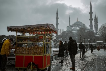 People buying food from a cart in snowy istanbul