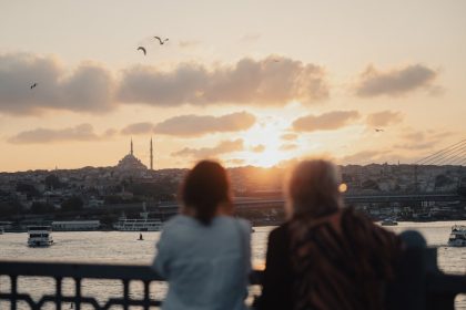 A couple of people that are looking at the water