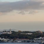 City skyline with historic buildings and a cloudy sky