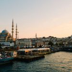 Stunning view of Istanbul with mosques and bustling harbor at sunset.