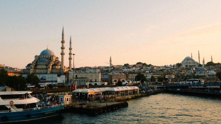 Stunning view of Istanbul with mosques and bustling harbor at sunset.