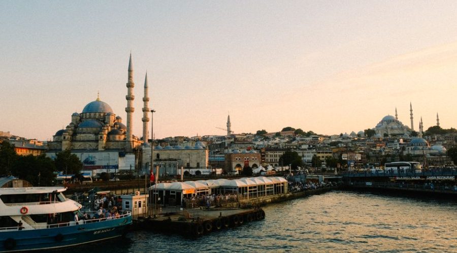 Stunning view of Istanbul with mosques and bustling harbor at sunset.