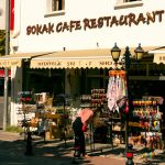 A woman shops outside a sokak cafe restaurant