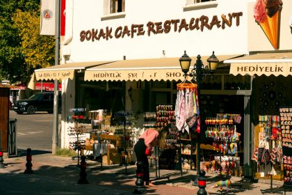A woman shops outside a sokak cafe restaurant