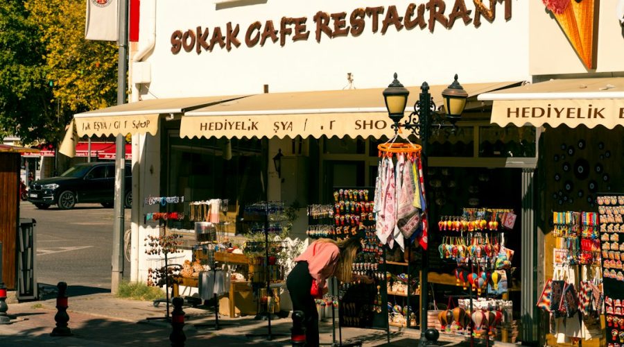 A woman shops outside a sokak cafe restaurant